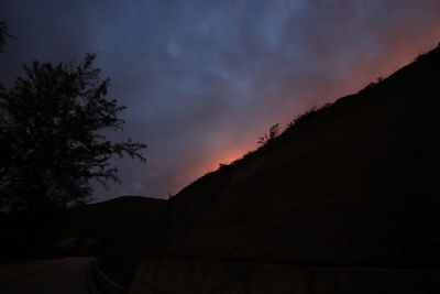 Scenic view of silhouette mountains against sky at night