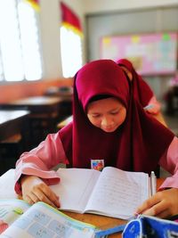 Confident girl studying in classroom