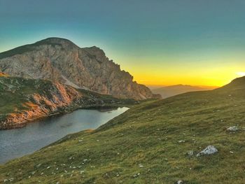 Scenic view of lake against sky during sunset