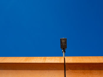 Low angle view of basketball hoop against clear blue sky