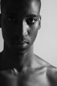 Portrait of shirtless man against white background