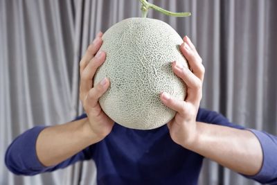 Close-up of man holding fruit