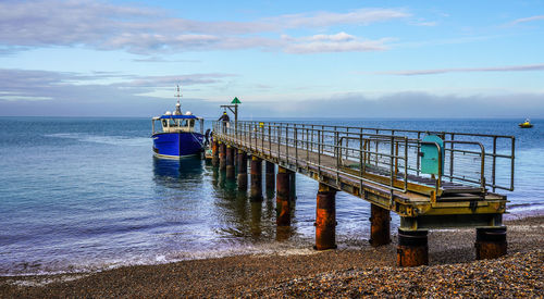 Pier over sea against sky