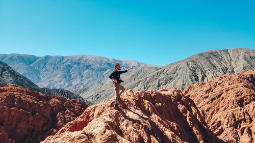 Full length of person on rock against sky