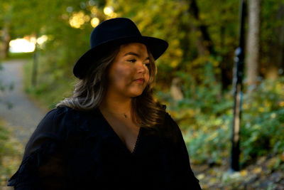 Portrait of young woman standing outdoors