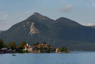 Panoramic view of lake and buildings against sky