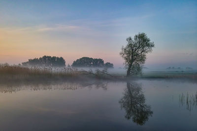 Scenic view of lake against sky during sunset