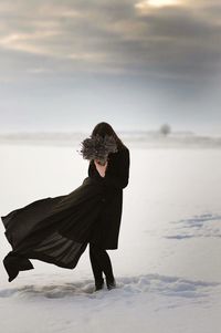 Silhouette of woman walking on road