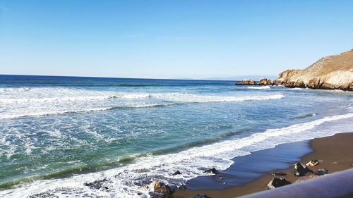 Scenic view of sea against clear blue sky