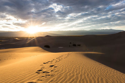 Scenic view of desert against sky during sunset