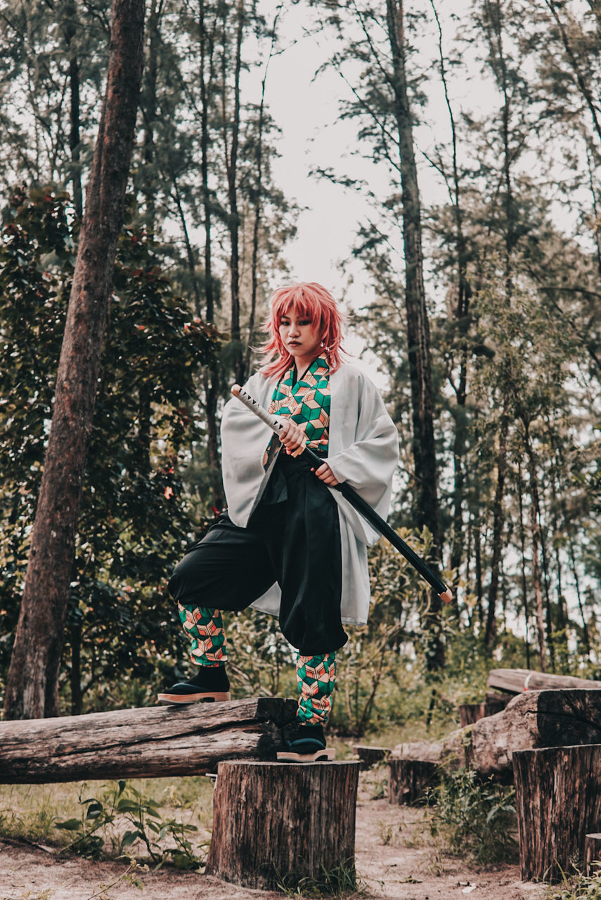 tree, full length, one person, plant, nature, adult, spring, clothing, women, leisure activity, front view, lifestyles, footwear, forest, day, outdoors, standing, land, portrait, emotion, winter, female, happiness, casual clothing, young adult, smiling, person