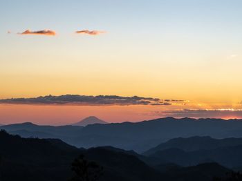 Scenic view of silhouette mountains against sky during sunset