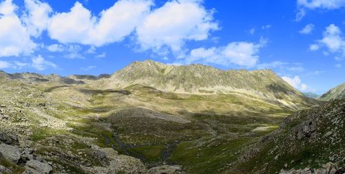 Scenic view of mountains against cloudy sky