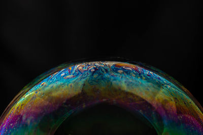 Close-up of bubbles over black background