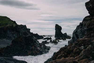 Scenic view of sea against cloudy sky