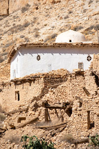 Scenic view of old stone houses, palm trees ghoufi canyon in the aures region, algeria