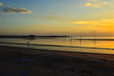 Scenic view of beach against sky during sunset