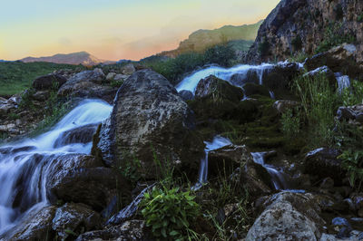 Scenic view of waterfall against rocks