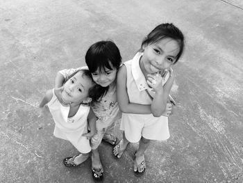 High angle portrait of smiling girls standing outdoors