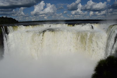 Scenic view of waterfall against sky