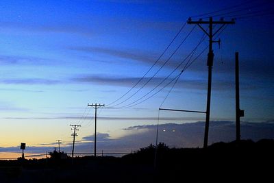 Low angle view of electricity pylon against sky