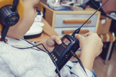 Midsection of man using mobile phone