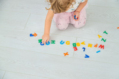 High angle view of girl playing with toys on table