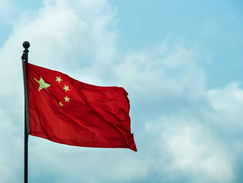 Low angle view of chinese flag against sky