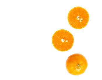 Close-up of orange fruit against white background