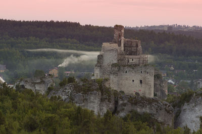 Castle on mountain against sky