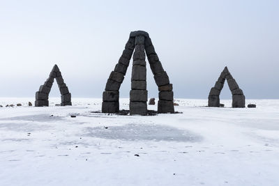 Built structure on snow covered land against clear sky