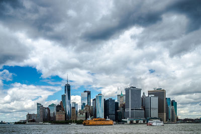 View of cityscape against cloudy sky