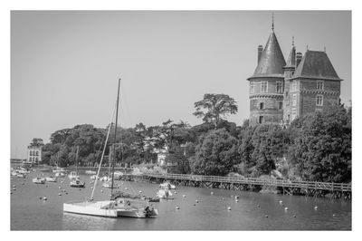 Sailboats in building against clear sky