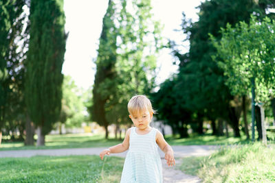 Portrait of woman standing on grass