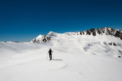 Full length of person on snowcapped mountain against sky