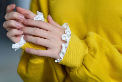 Details of yellow sweater