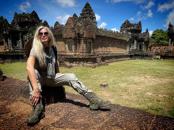 Portrait of young woman standing on field