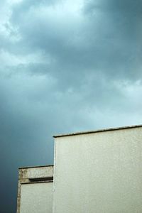 Low angle view of building against cloudy sky