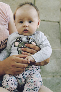 Portrait of cute baby boy sitting outdoors