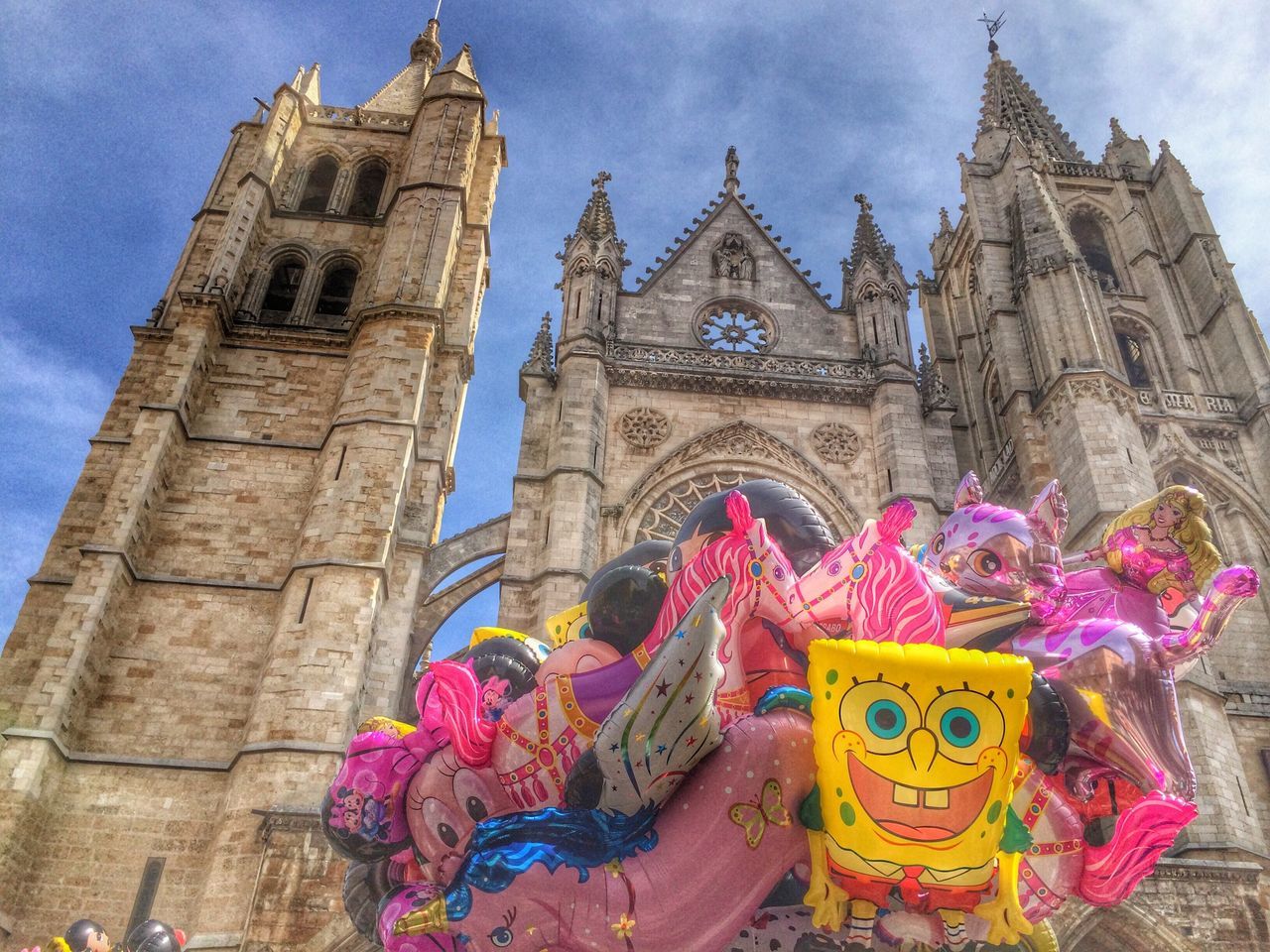 religion, place of worship, spirituality, church, building exterior, architecture, built structure, low angle view, sky, cathedral, flower, famous place, cross, history, travel destinations, travel, temple - building, day