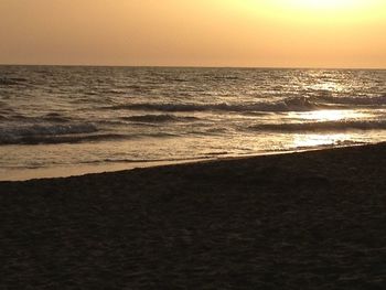 Scenic view of beach against sky during sunset