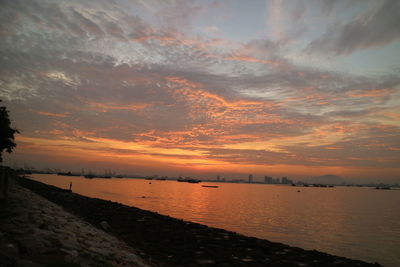 Scenic view of sea against orange sky