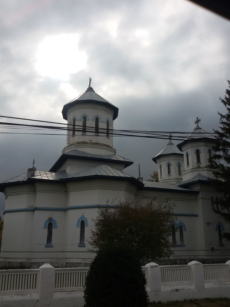 architecture, built structure, building exterior, sky, religion, cloud - sky, spirituality, place of worship, low angle view, no people, outdoors, day, bell tower, tree