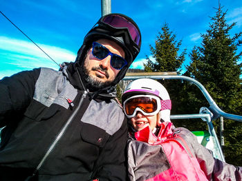 Portrait of smiling boy wearing sunglasses against sky