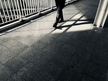 Low section of man walking on footpath