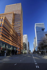 View of city street against blue sky