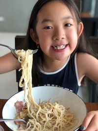 Portrait of girl having noodles