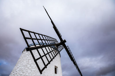 Low angle view of traditional windmill against sky