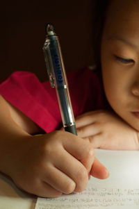 Close-up of boy holding paper