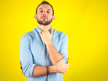 Portrait of man against yellow background